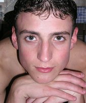 Soulful dark-haired twink posing in the kitchen