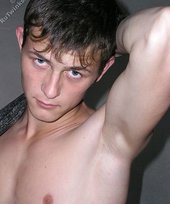 Slender twink posing shirtless in a ruined apartment