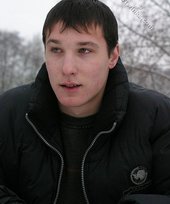 Dark-haired young Russian twink posing outdoors