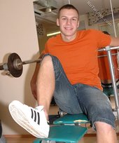 Orange t-shirt stud decides to pose seductively