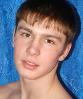 Dark-haired boy posing totally naked in a studio