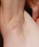 Naughty twink with a sad look in his face posing on all fours