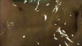 Dark-haired hottie fingering in the hot tub