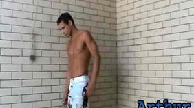 Latino guy jerking his cock next to the pool