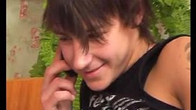 Two twinks enjoying each other's lips next to a laptop