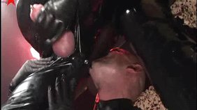 Latex-wearing gasmask goon getting his asshole gaped by the master